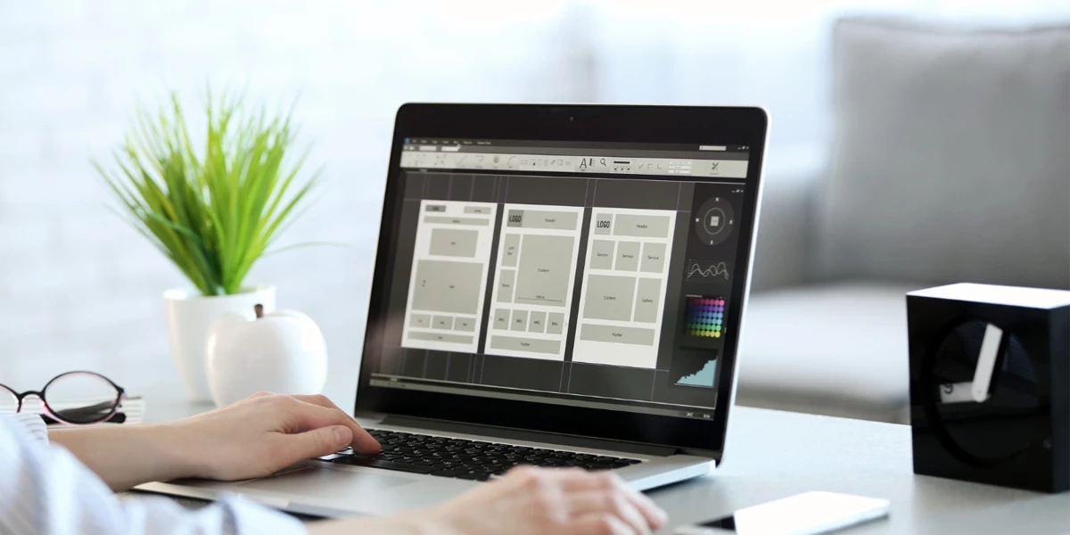 Wireframe design process for a modern digital agency website displayed on a laptop screen